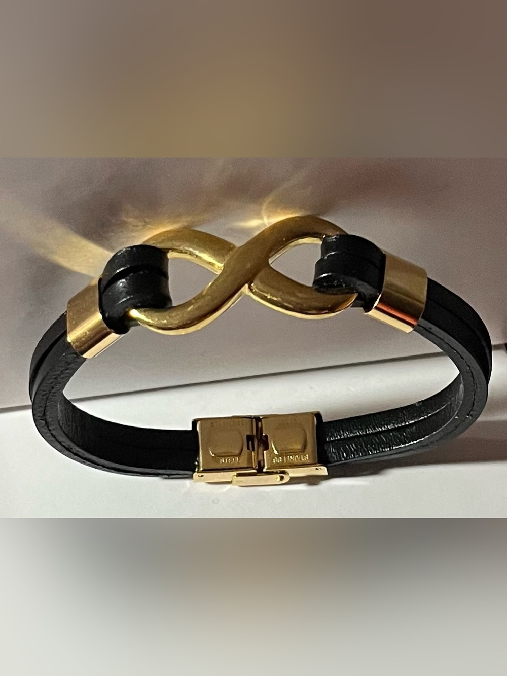 Black Faux Leather Bracelet with Gold tone Infinity Link, and hardware. (NWOT)